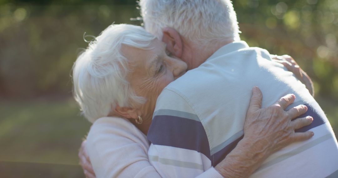 Joyful Senior Couple Embracing in Sunlit Garden
