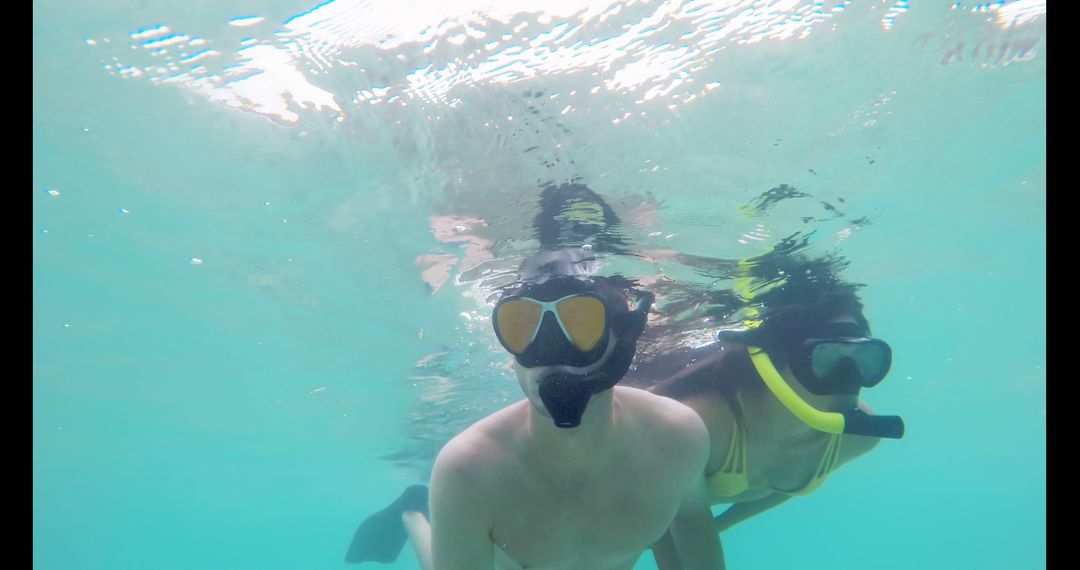 Couple Snorkeling Together in Turquoise Sea Wearing Masks - Free Images, Stock Photos and Pictures on Pikwizard.com