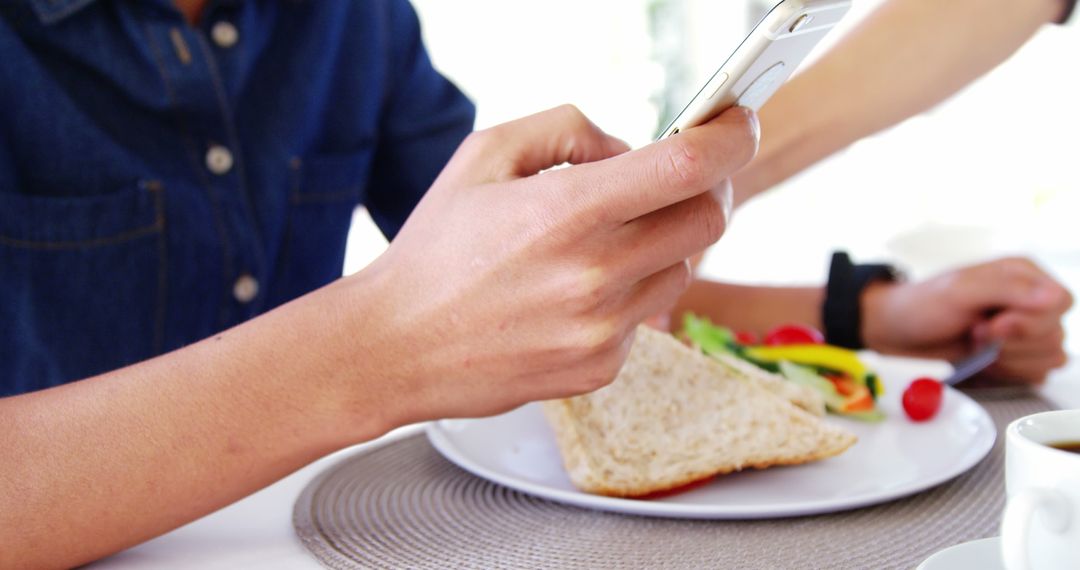 Using Smartphone While Eating Breakfast with Healthy Sandwich - Free Images, Stock Photos and Pictures on Pikwizard.com