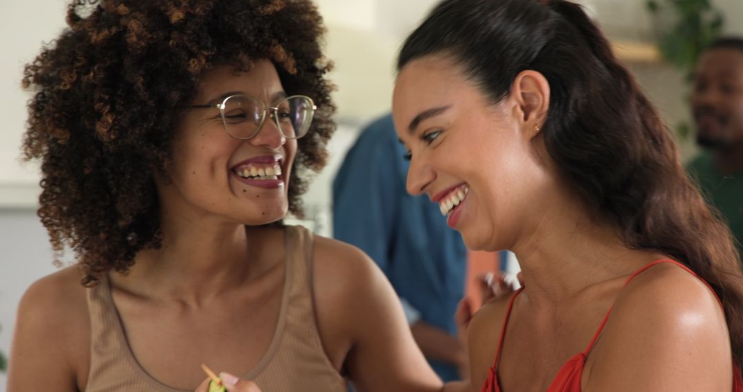 Diverse Female Friends Smiling and Sharing Bite to Eat at Home