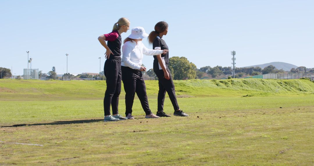Female Coach Guiding Athletes on Playing Field