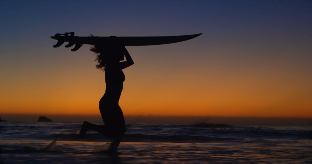 Silhouette of Woman Surfing at Sunset with Vibrant Sky - Free Images, Stock Photos and Pictures on Pikwizard.com