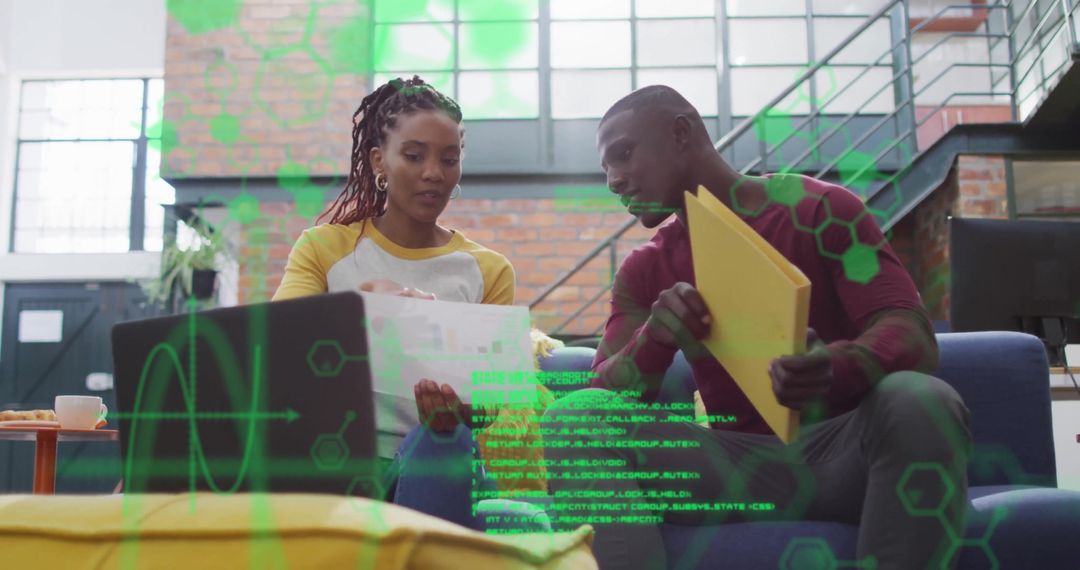 Colleagues Reviewing Documents in Modern Creative Workspace