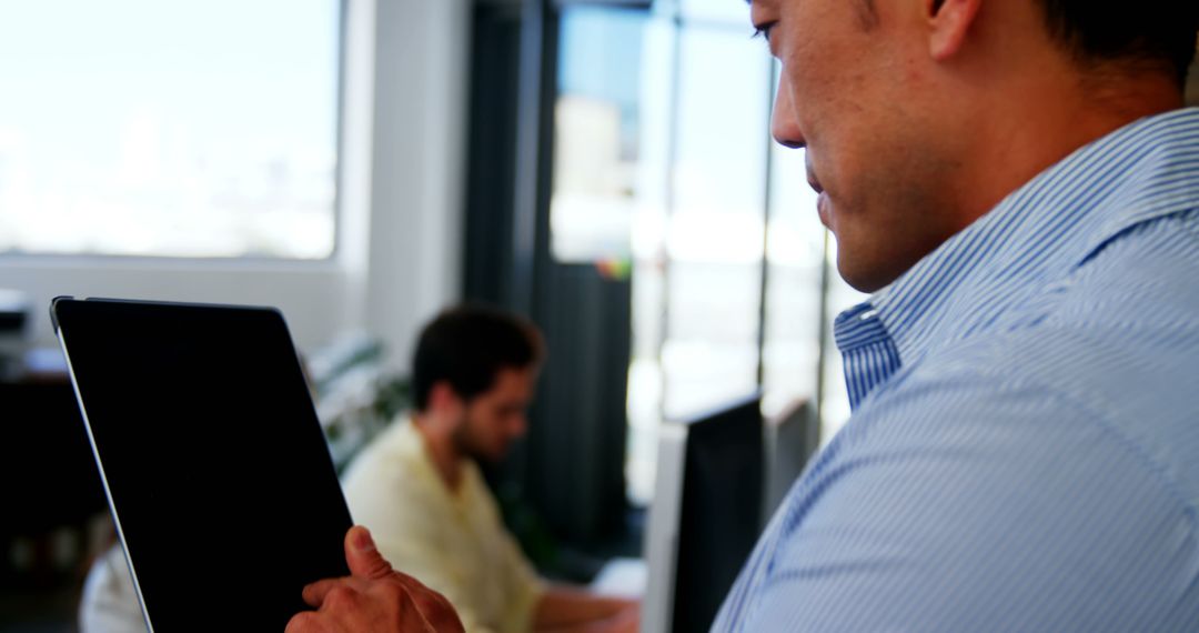 Business Executive Analyzing Data on Digital Tablet in Office
