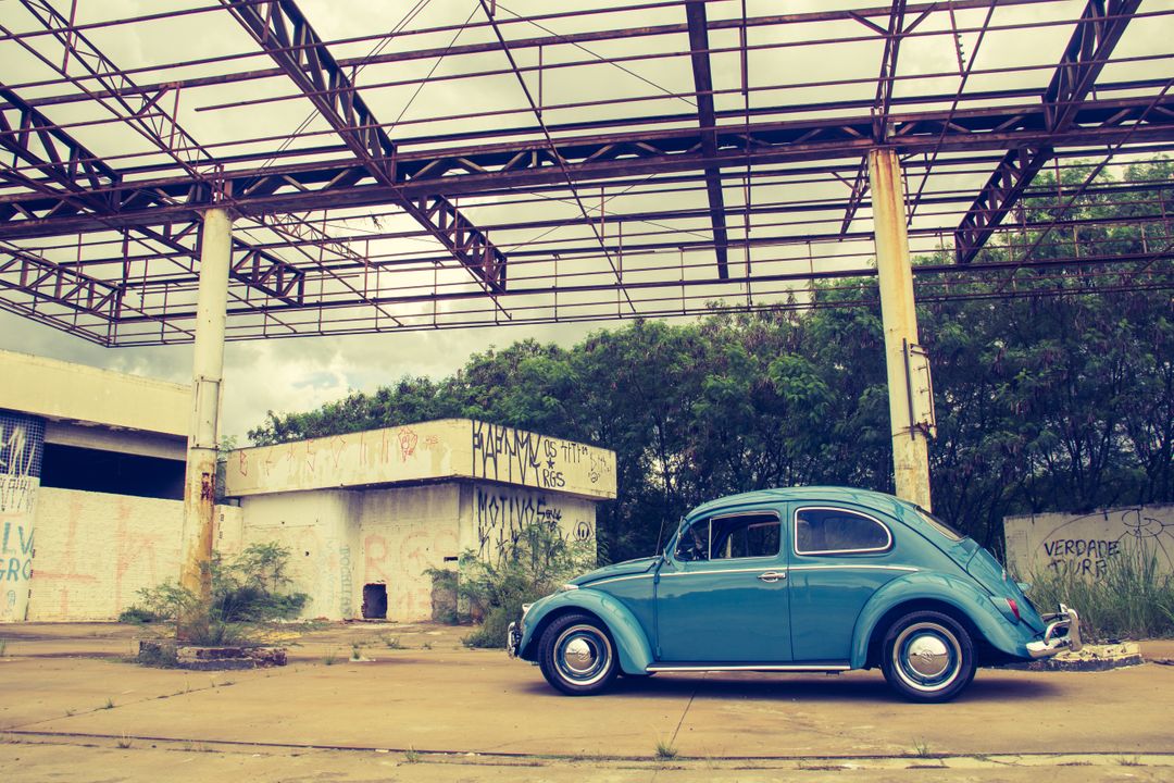 Vintage Blue Beetle Parked at Abandoned Gas Station Under Metal Structure - Free Images, Stock Photos and Pictures on Pikwizard.com