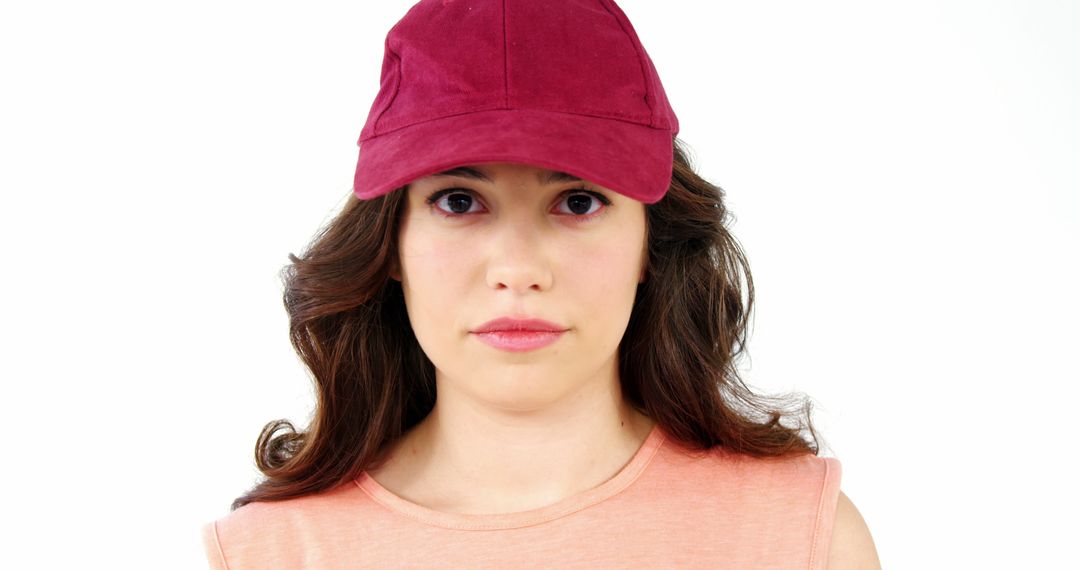 A young Caucasian woman wears a casual red cap and a pink top, with copy space - Free Images, Stock Photos and Pictures on Pikwizard.com