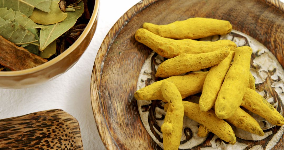 Fresh Turmeric Roots and Bay Leaves in Wooden Bowls - Free Images, Stock Photos and Pictures on Pikwizard.com