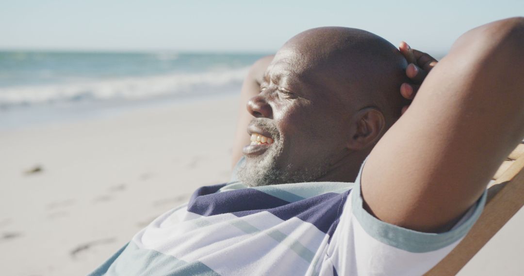 Relaxing African American Man Sunbathing on Beach - Free Images, Stock Photos and Pictures on Pikwizard.com