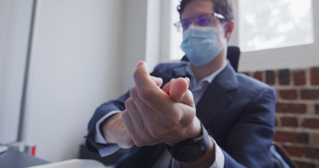 Businessman Popping Teammate Hand Gesture in Office During Daytime - Free Images, Stock Photos and Pictures on Pikwizard.com