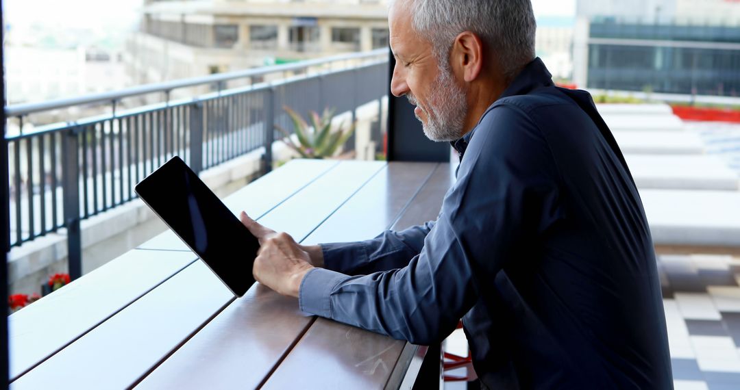 Businessman Using Tablet at Outdoor Cafe - Free Images, Stock Photos and Pictures on Pikwizard.com