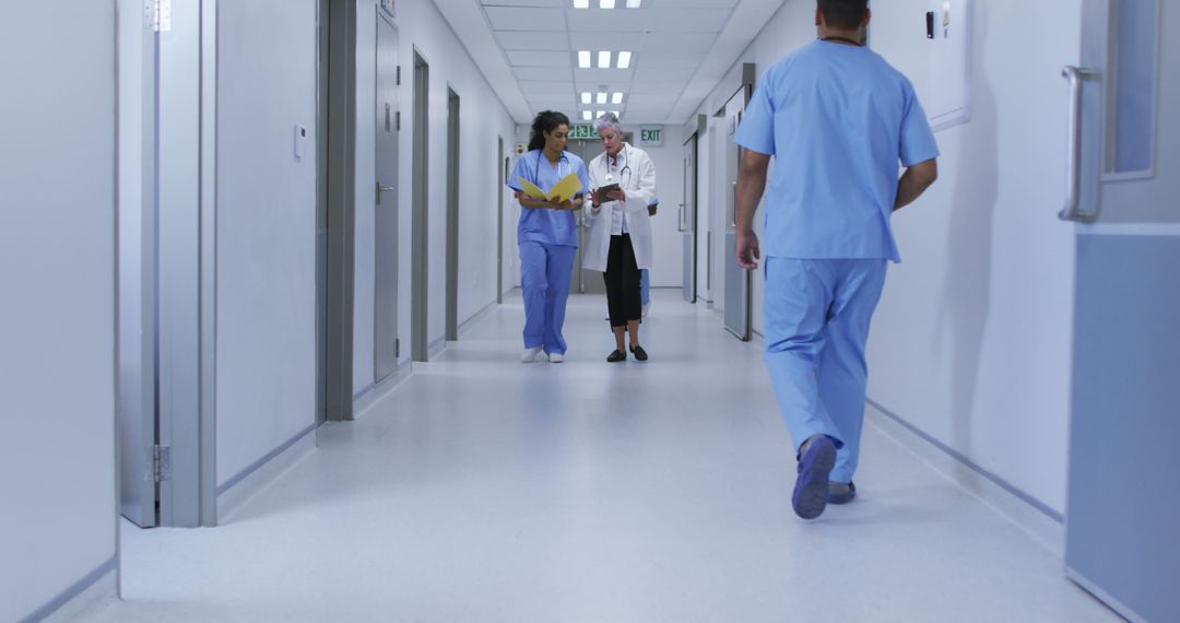 Doctors and Nurses Walking Through Hospital Corridor - Free Images, Stock Photos and Pictures on Pikwizard.com