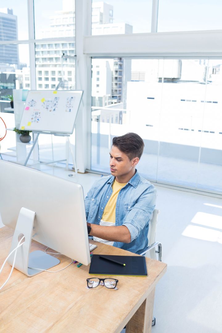 Professional Designer Working on Tablet in Modern Office with City View