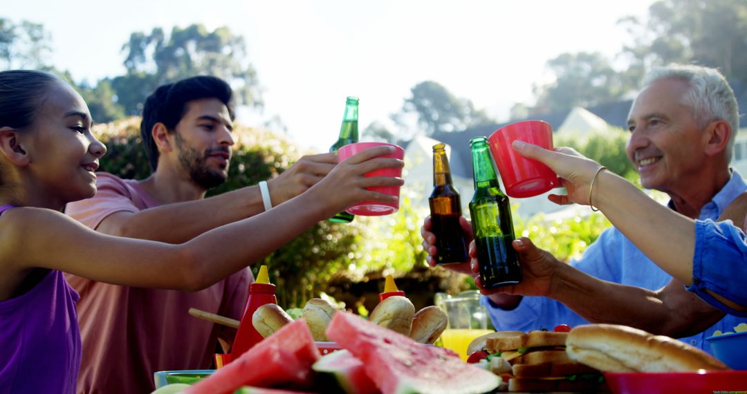 Diverse Group Toasting at Outdoor Meal Enjoying Togetherness