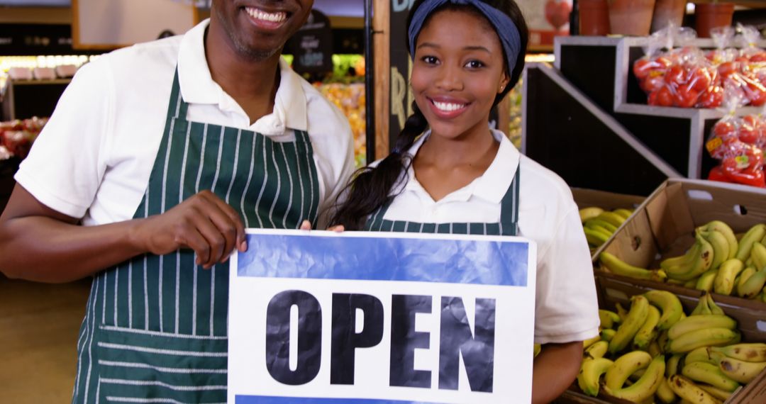 Grocery Store Employees Holding Open Sign - Free Images, Stock Photos and Pictures on Pikwizard.com