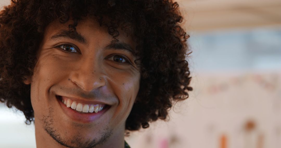 Happy Young Man With Curly Hair Smiling - Free Images, Stock Photos and Pictures on Pikwizard.com