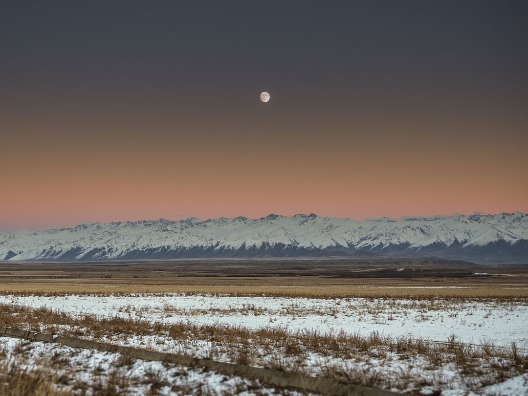 Full Moon Rising Over Snowy Mountain Range at Dawn - Free Images, Stock Photos and Pictures on Pikwizard.com