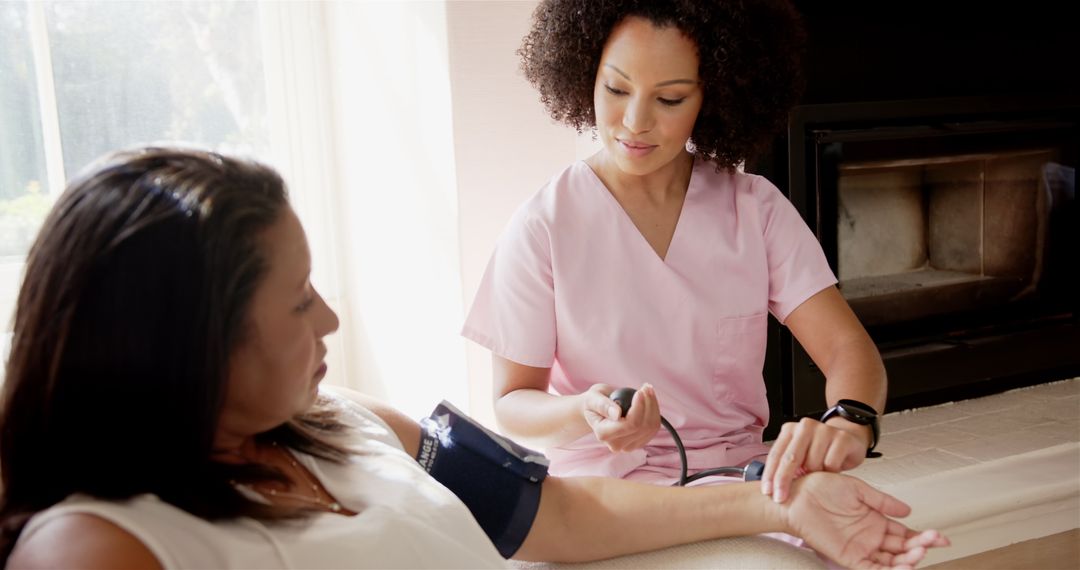Nurse Monitoring Patient's Blood Pressure at Home