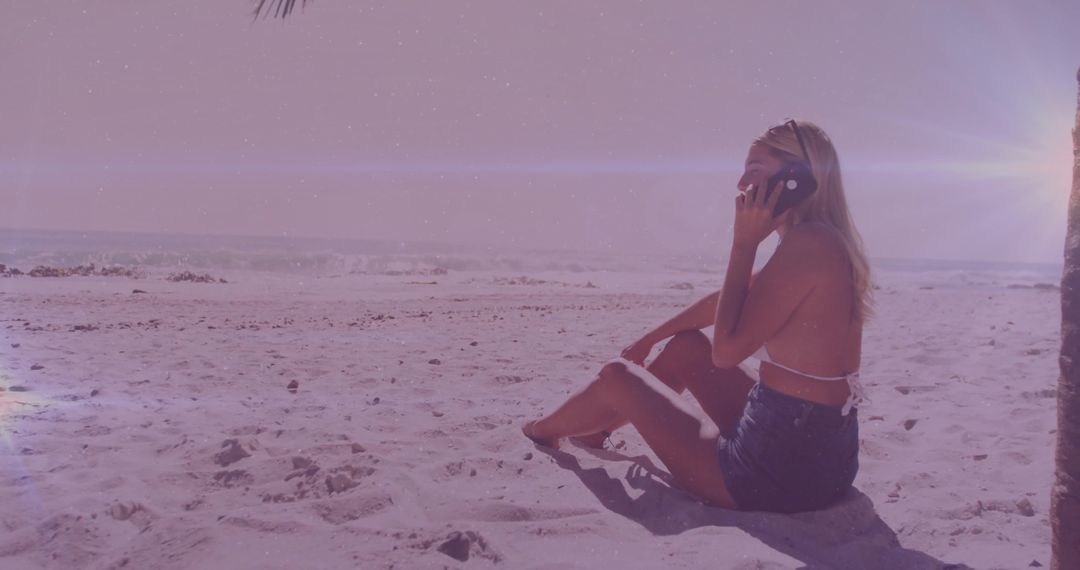 Young Woman Enjoying Beach Sunset While Talking on Smartphone