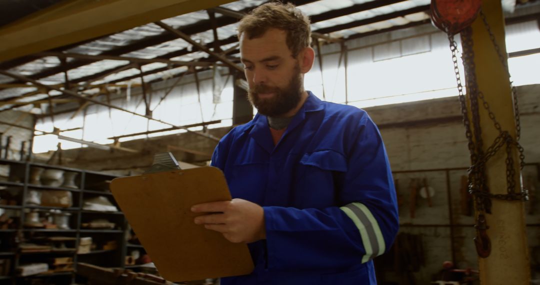 Industrial Factory Worker Writing Report on Clipboard - Free Images, Stock Photos and Pictures on Pikwizard.com