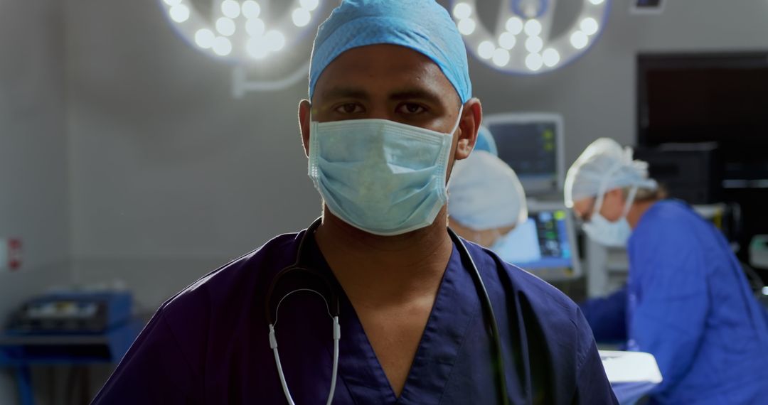 Front view of African-american male surgeon standing in the operation theater at hospital - Free Images, Stock Photos and Pictures on Pikwizard.com