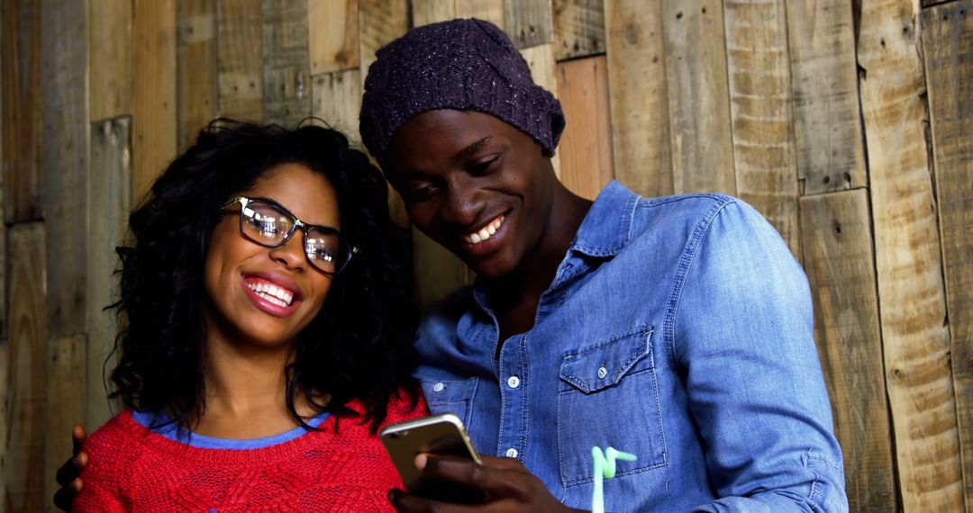 Happy Couple Enjoying Smartphone Moment in Rustic Cafe