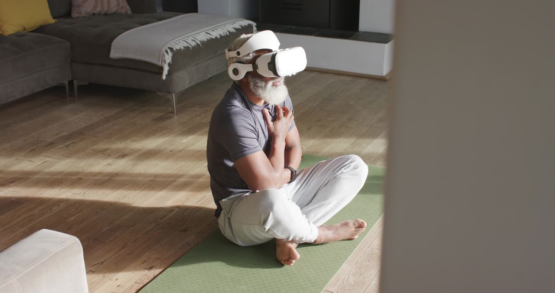 Senior Man Meditating With VR Headset at Home