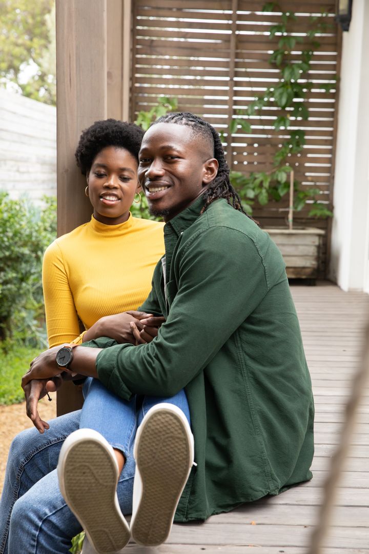 Couple Embracing on Rustic Deck in Outdoor Setting