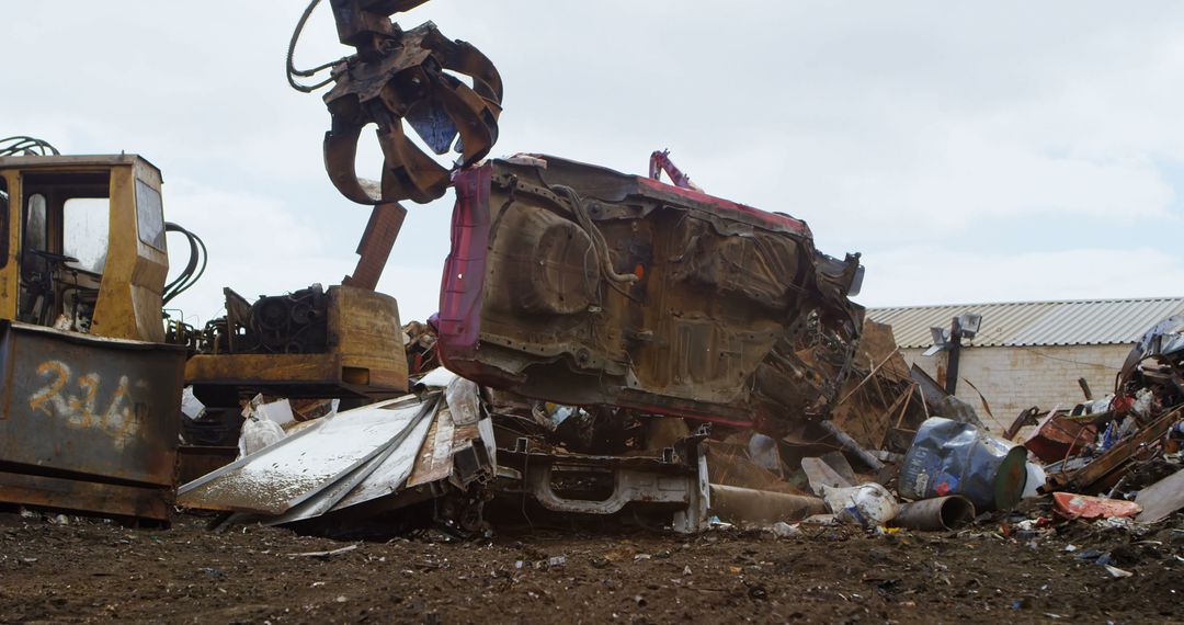 Heavy Machinery Lifting Crashed Car at Scrap Yard - Free Images, Stock Photos and Pictures on Pikwizard.com