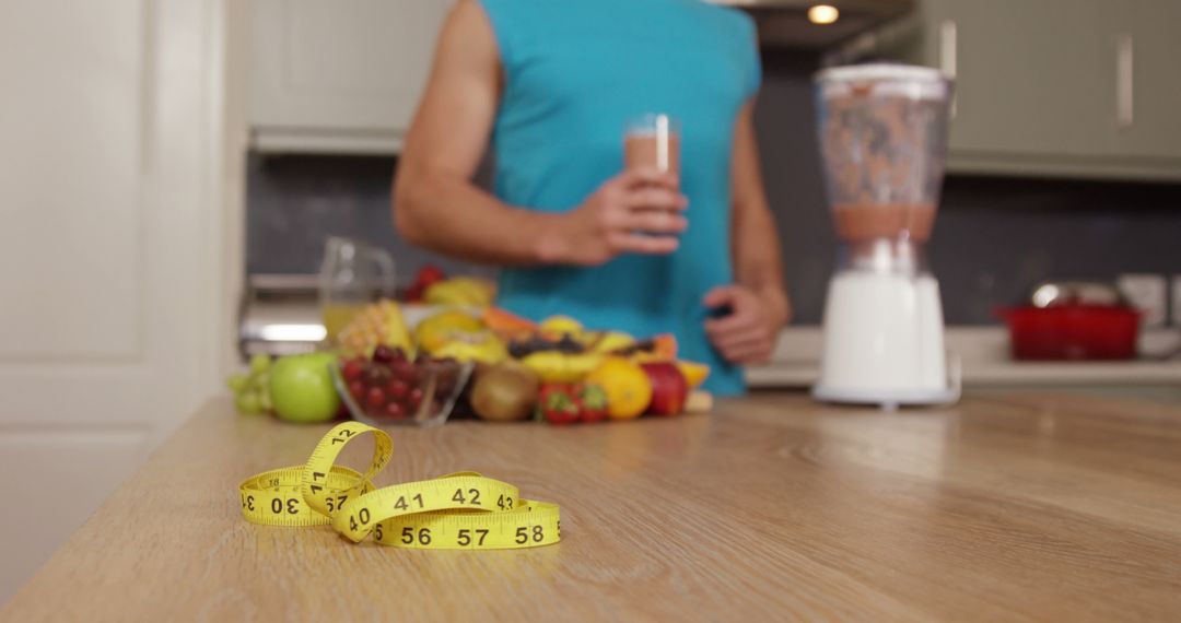 Healthy Lifestyle Concept with Juice, Fruits, and Tape Measure on Kitchen Table - Free Images, Stock Photos and Pictures on Pikwizard.com