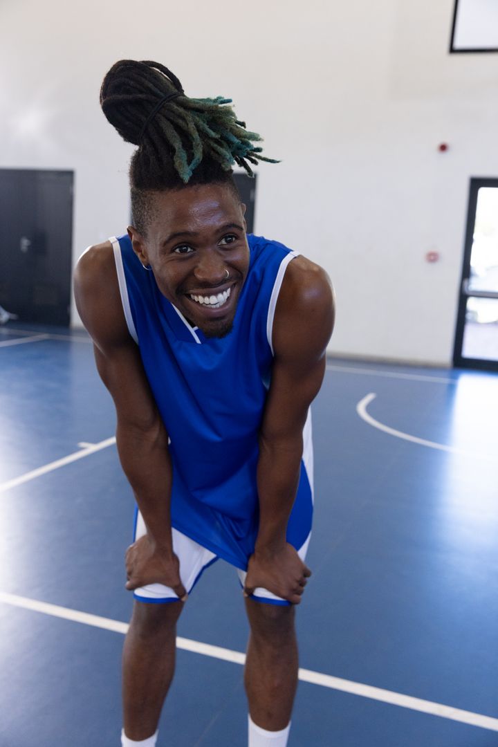Energetic Basketball Player Smiling after a Game on Court
