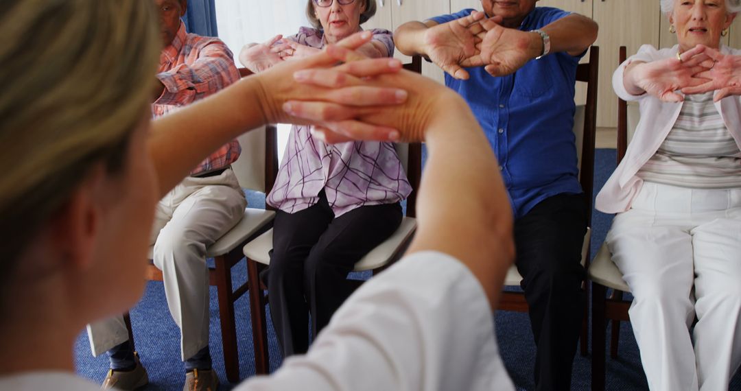 Elderly Group Participating in Seated Exercises in Senior Home - Free Images, Stock Photos and Pictures on Pikwizard.com