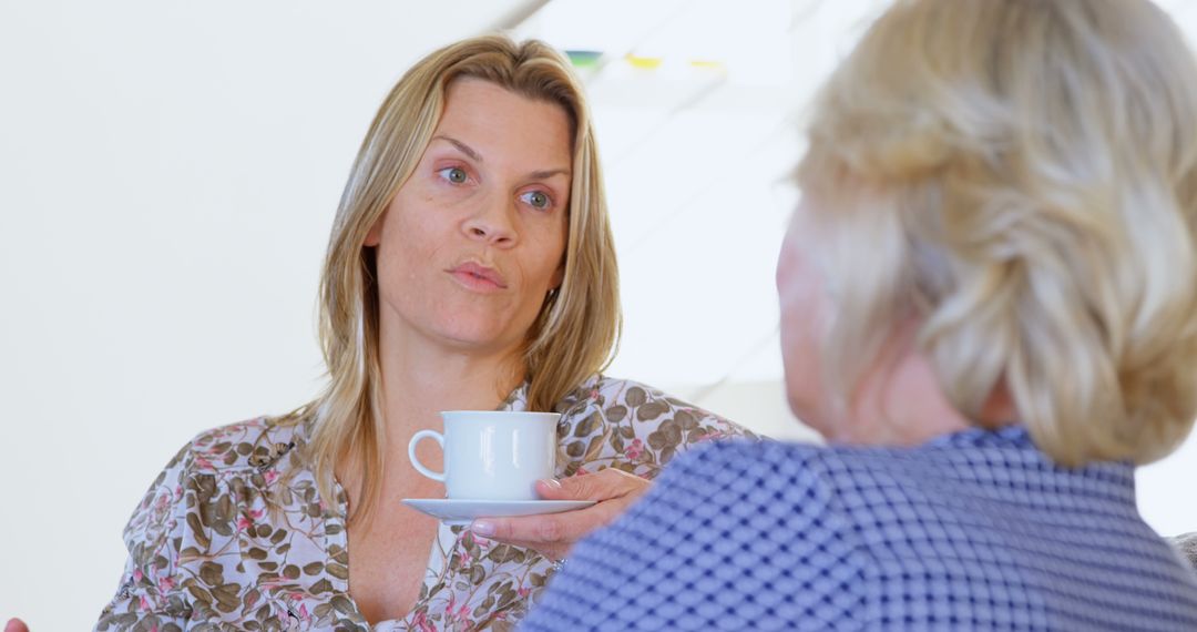 Women having serious conversation while drinking coffee - Free Images, Stock Photos and Pictures on Pikwizard.com