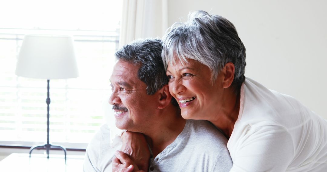 Happy Senior Couple Embracing with Joyful Smiles at Home