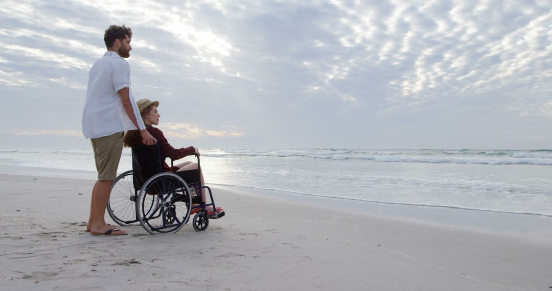 Caregiver and Senior Woman in Wheelchair Enjoying Beach Sunset - Free Images, Stock Photos and Pictures on Pikwizard.com