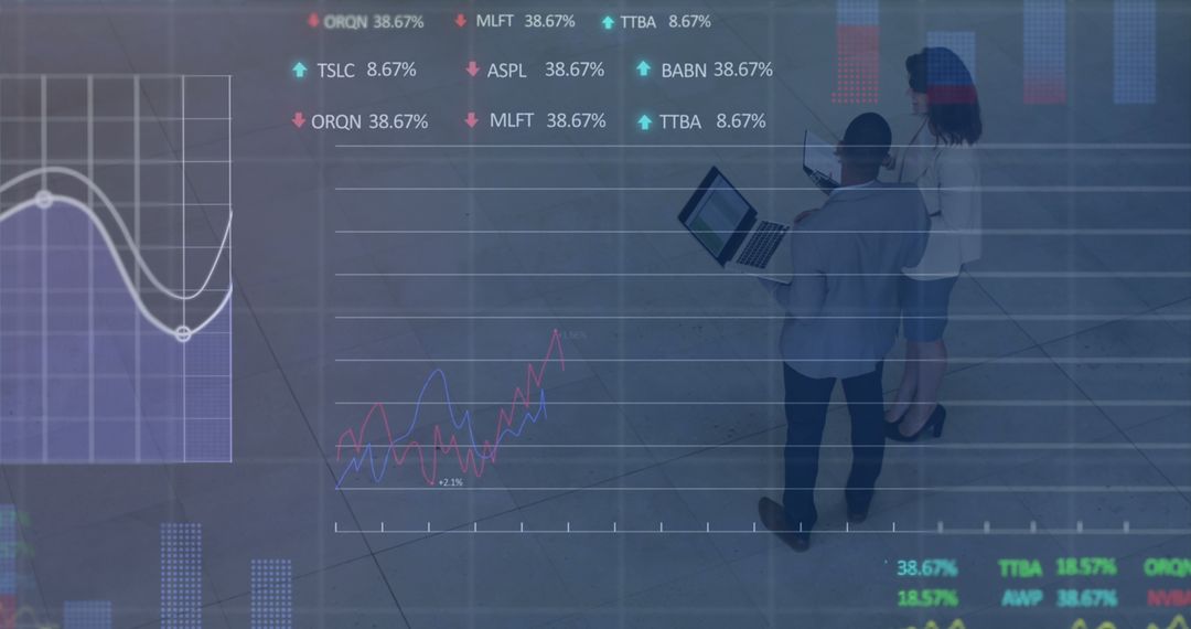 Diverse Co-Workers Analyzing Financial Data on Laptop in Modern Office