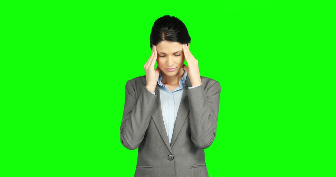 A stressed businesswoman shows signs of discomfort against a green screen with copy space. - Free Images, Stock Photos and Pictures on Pikwizard.com