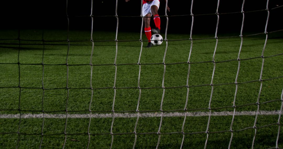 Soccer Player Dribbling Ball on Field at Night with Goal Post View - Free Images, Stock Photos and Pictures on Pikwizard.com