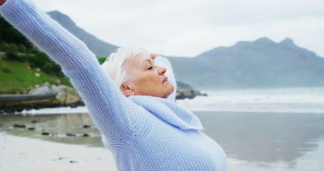 Senior Woman Enjoying Fresh Air at Seaside - Free Images, Stock Photos and Pictures on Pikwizard.com