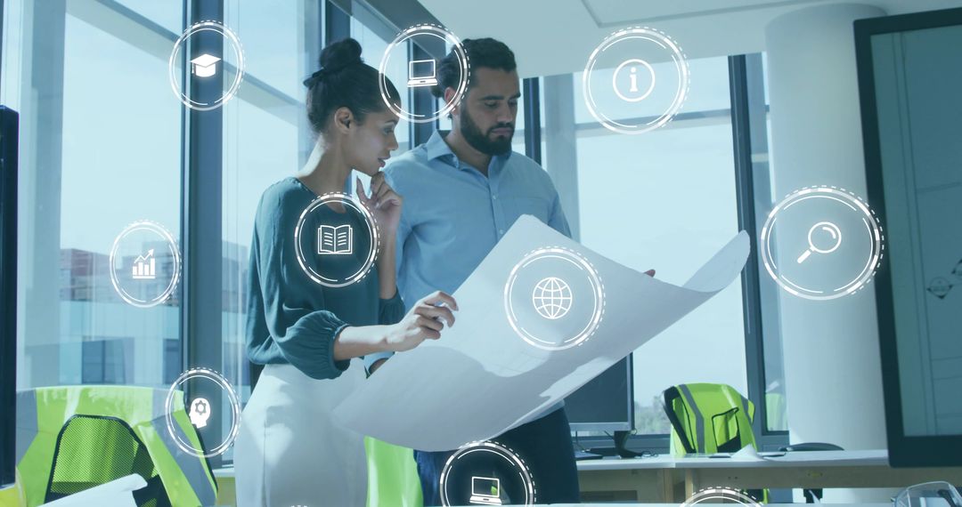 Colleagues Reviewing Blueprint with Digital Icons Representing Collaboration and Innovation