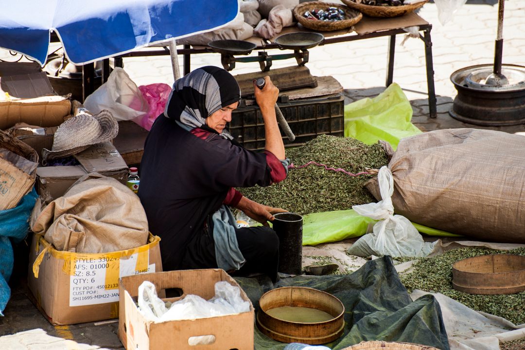 Traditional Market Vendor Preparing Spices in Outdoor Bazaar - Free Images, Stock Photos and Pictures on Pikwizard.com