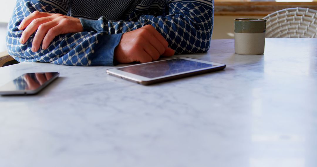 Man Relaxing at Home with Digital Devices on Marble Table