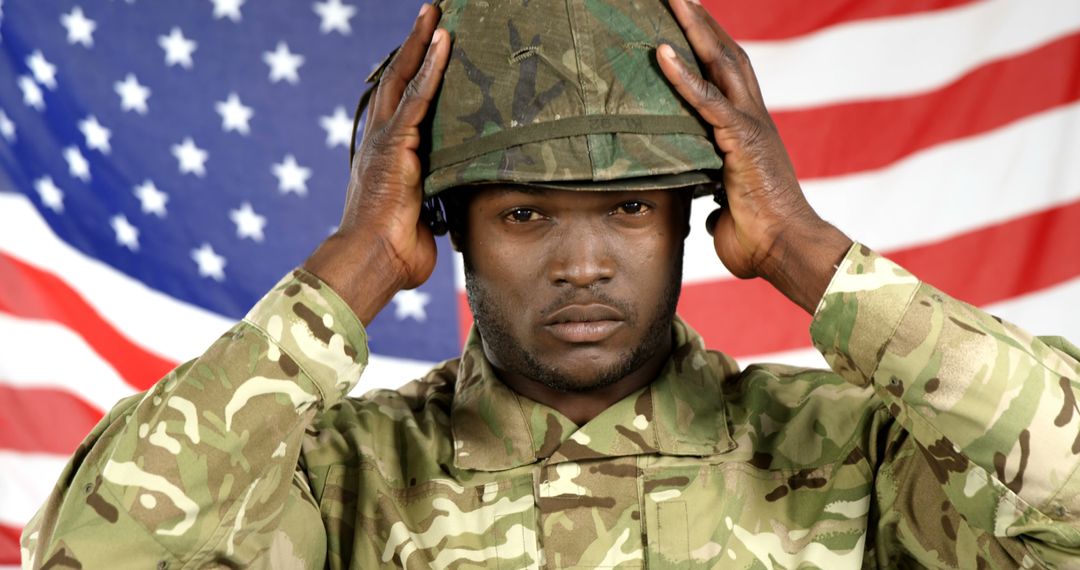 African American Soldier Adjusting Helmet with American Flag Background - Free Images, Stock Photos and Pictures on Pikwizard.com