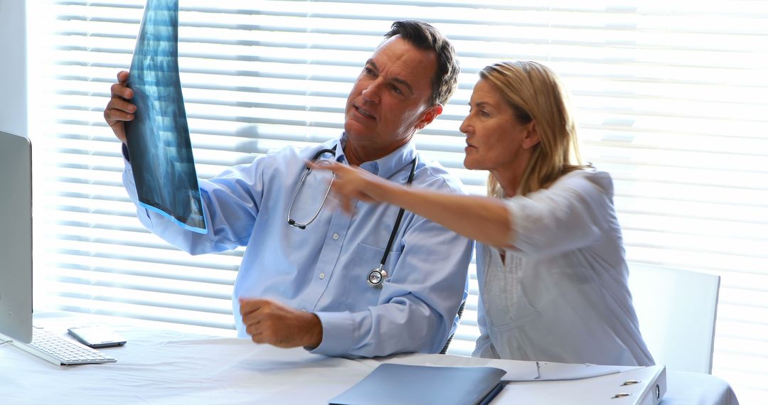 Doctor and Patient Reviewing X-Ray Results in Office - Free Images, Stock Photos and Pictures on Pikwizard.com