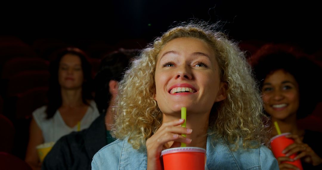 Joyful Young Woman Enjoying Movie at Cinema with Friends - Free Images, Stock Photos and Pictures on Pikwizard.com