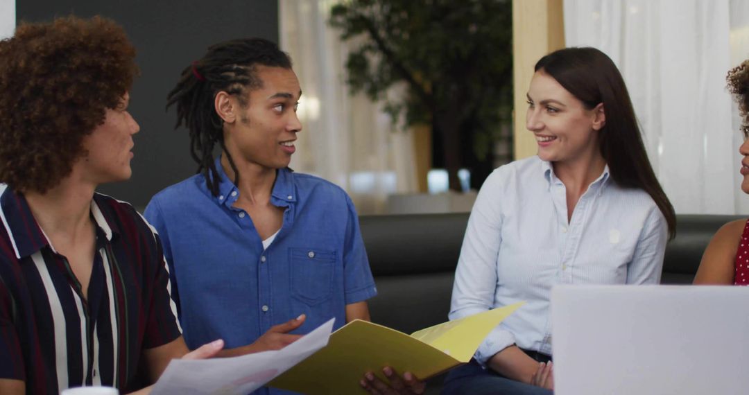 Colleagues Discussing in Casual Office Lounge Meeting