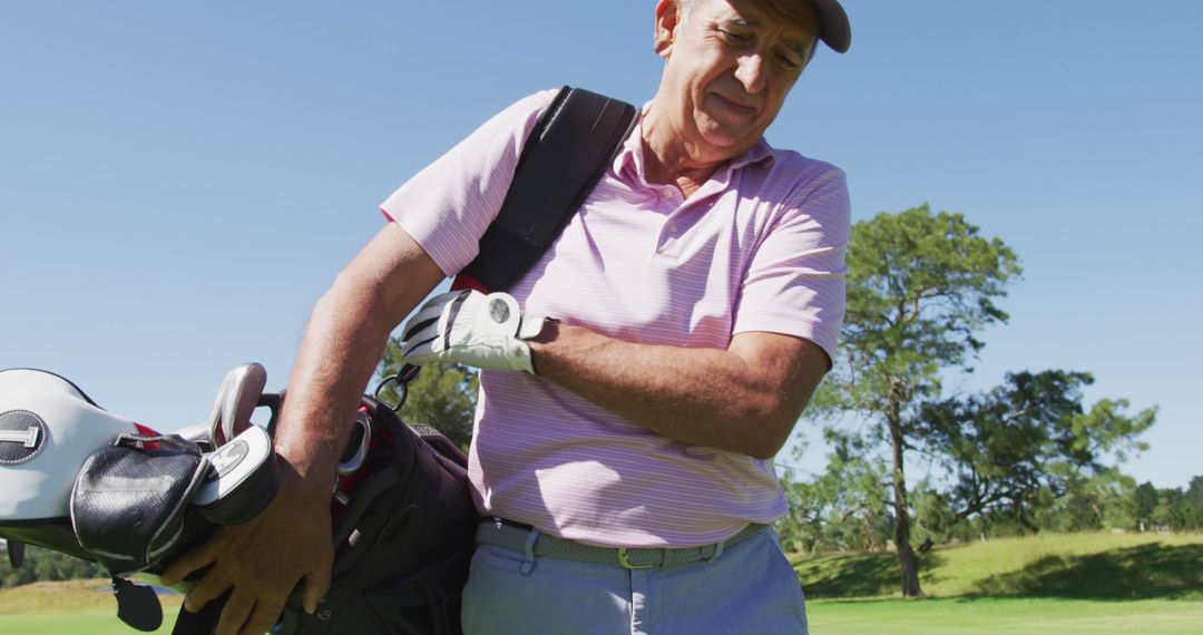 Senior Man Carrying Golf Bag on Bright Sunny Golf Course - Free Images, Stock Photos and Pictures on Pikwizard.com