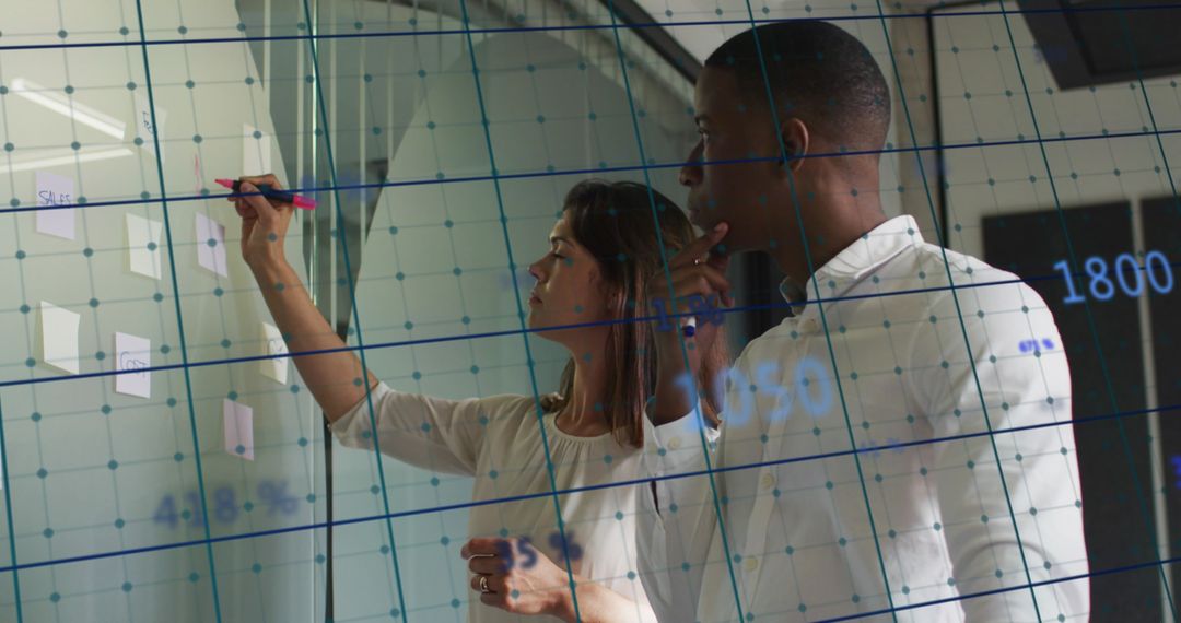 Business Professionals Analyzing Data on Interactive Board