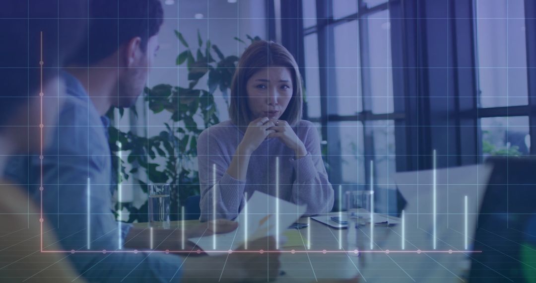 Business Team Discussing Data Analysis with Digital Graph Overlay