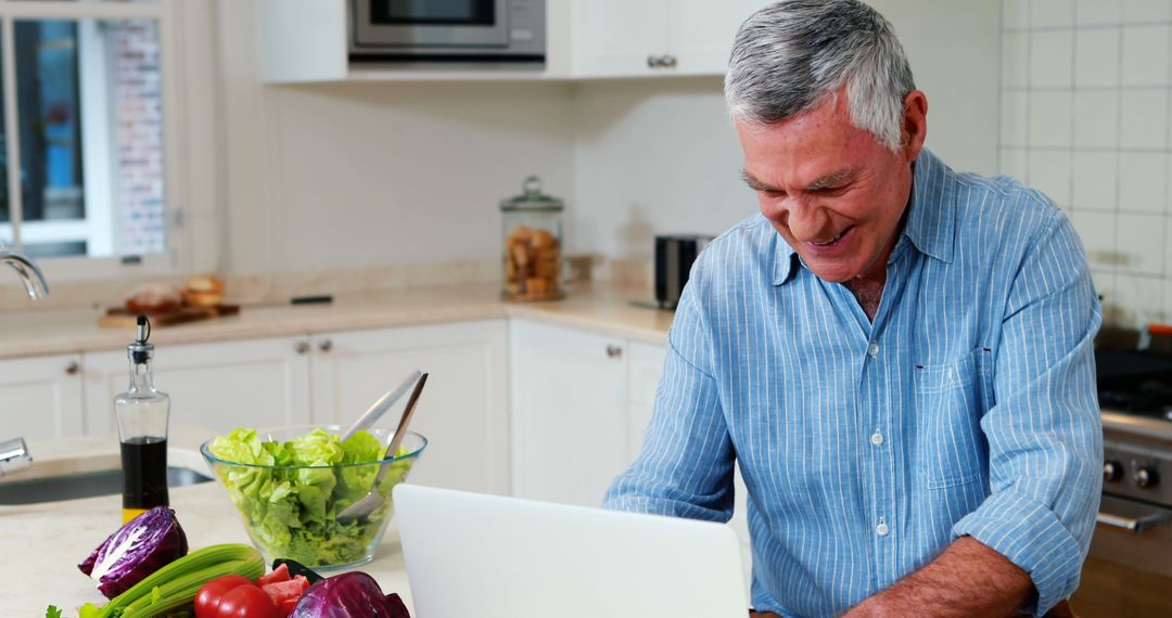 Senior Man Engaging with Technology in Modern Kitchen with Vegetables - Free Images, Stock Photos and Pictures on Pikwizard.com