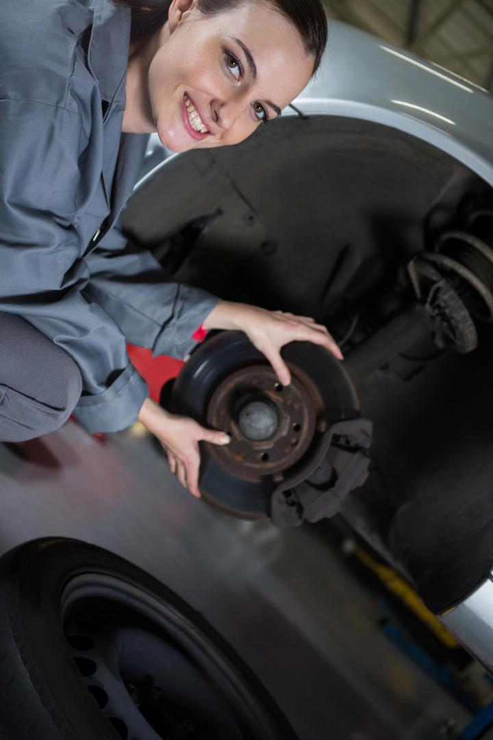 Female mechanic fixing car brake - Free Images, Stock Photos and Pictures on Pikwizard.com
